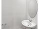 Simple bathroom with a single sink and an oval mirror at 14824 Lyla Ter, Bradenton, FL 34211