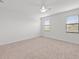 Well-lit bedroom with neutral colored carpet and two windows at 14824 Lyla Ter, Bradenton, FL 34211