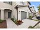 Front view of townhome with gray exterior, landscaping, and walkway at 14824 Lyla Ter, Bradenton, FL 34211