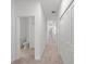 Long hallway with carpet, doors to bedrooms and a bathroom at 14824 Lyla Ter, Bradenton, FL 34211