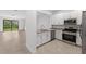 Modern kitchen with white cabinets, granite countertops, and stainless steel appliances at 14824 Lyla Ter, Bradenton, FL 34211
