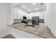 Kitchen island with granite countertops and white cabinets at 14824 Lyla Ter, Bradenton, FL 34211