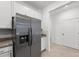 Stainless steel refrigerator in modern kitchen with white cabinets at 14824 Lyla Ter, Bradenton, FL 34211