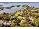 Aerial view showing community pool, lush landscaping, and waterfront access at 1512 Pelican Cove Rd # 239, Sarasota, FL 34231
