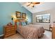 Spacious bedroom with wood floors, accent wall, and ample natural light at 1512 Pelican Cove Rd # 239, Sarasota, FL 34231