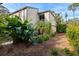 Exterior view of condo with lush landscaping and walkway at 1512 Pelican Cove Rd # 239, Sarasota, FL 34231