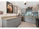 Modern kitchen with gray cabinets, granite counters and stainless steel appliances at 1512 Pelican Cove Rd # 239, Sarasota, FL 34231