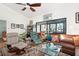 Bright living room with comfy seating and a view to the patio at 1512 Pelican Cove Rd # 239, Sarasota, FL 34231