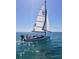 Couple enjoying a sailboat ride on the open water at 1512 Pelican Cove Rd # 239, Sarasota, FL 34231