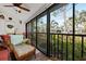 Bright screened porch boasts wicker furniture and tranquil nature views at 1512 Pelican Cove Rd # 239, Sarasota, FL 34231