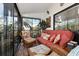 Comfortable screened porch featuring wicker furniture and colorful accents at 1512 Pelican Cove Rd # 239, Sarasota, FL 34231
