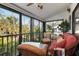 Relaxing screened porch with wicker furniture and lush foliage views at 1512 Pelican Cove Rd # 239, Sarasota, FL 34231