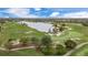 Aerial view of lush green golf course and lake at 15608 Leven Links Pl, Lakewood Ranch, FL 34202