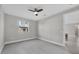 Spacious bedroom with ceiling fan and sliding door to hallway at 1732 Jagust Rd, North Port, FL 34288