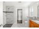 Renovated bathroom with marble shower, double vanity, and walk-in closet at 1790 S Biscayne Dr, North Port, FL 34287