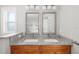 Bathroom with granite countertop, double sinks, and large mirrors at 1790 S Biscayne Dr, North Port, FL 34287