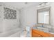 Bathroom with marble tile, granite vanity and bathtub at 1790 S Biscayne Dr, North Port, FL 34287