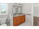 Bathroom with wood cabinets, double sinks, and granite countertop at 1790 S Biscayne Dr, North Port, FL 34287