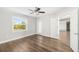 Bedroom with wood floors, window, and access to another room at 1790 S Biscayne Dr, North Port, FL 34287