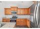 Well-equipped kitchen with wood cabinets and granite countertops at 1790 S Biscayne Dr, North Port, FL 34287