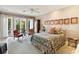 Bedroom with a floral patterned bed and access to the patio at 1804 N Lake Shore Dr, Sarasota, FL 34231