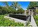 Modern water fountain featuring a square basin and frog statues at 1804 N Lake Shore Dr, Sarasota, FL 34231