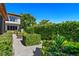 Mature hedges, gravel pathway, and manicured boxwoods create a serene garden at 1804 N Lake Shore Dr, Sarasota, FL 34231