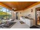 Relaxing screened porch with built-in grill and dining area at 1804 N Lake Shore Dr, Sarasota, FL 34231