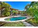 Inviting kidney-shaped pool surrounded by tropical landscaping at 1804 N Lake Shore Dr, Sarasota, FL 34231