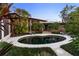 Kidney-shaped pool with surrounding patio and landscaping at 1804 N Lake Shore Dr, Sarasota, FL 34231