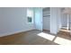 A bright bedroom with light wood floors and a closet and sliding doors at 2133 Hopwood Rd, North Port, FL 34287