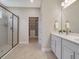 Elegant bathroom featuring double vanity and walk-in shower at 2219 Greenley Rd, North Port, FL 34286