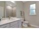 Clean bathroom with white vanity, gray tile shower, and a window at 2219 Greenley Rd, North Port, FL 34286