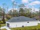 White house with gray roof, two-car garage, and green lawn at 2219 Greenley Rd, North Port, FL 34286