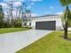 Modern house exterior with gray garage door and driveway at 2219 Greenley Rd, North Port, FL 34286