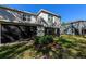 Back exterior of house showing a screened patio and yard at 2415 Midnight Pearl Dr, Sarasota, FL 34240