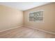 Bright bedroom featuring wood-look floors and a window at 25100 Sandhill Blvd # 102, Punta Gorda, FL 33983