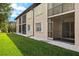 Building exterior showcasing a well-maintained lawn and screened patio at 25100 Sandhill Blvd # 102, Punta Gorda, FL 33983
