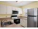 Kitchen with stainless steel appliances and white cabinets at 25100 Sandhill Blvd # 102, Punta Gorda, FL 33983