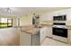 Condo kitchen with stainless steel appliances and light wood cabinets at 25100 Sandhill Blvd # 102, Punta Gorda, FL 33983