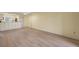 Open living area with kitchen access and wood-look floors at 25100 Sandhill Blvd # 102, Punta Gorda, FL 33983