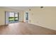 Living room with sliding glass doors and wood-look floors at 25100 Sandhill Blvd # 102, Punta Gorda, FL 33983