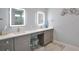 Double vanity bathroom with quartz countertops, modern fixtures, and a large mirror at 262 Island Cir, Sarasota, FL 34242