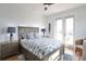 Bedroom with coastal bedding and French doors to balcony at 262 Island Cir, Sarasota, FL 34242