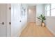 Light and airy hallway with white doors and light oak hardwood floors at 262 Island Cir, Sarasota, FL 34242