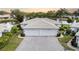 Two-car garage, tile roof, and landscaped grounds at 3020 Ringwood Mdw # 11, Sarasota, FL 34235