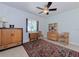 Cozy bedroom features a ceiling fan and a decorative area rug over tile floor at 309 South Dr, Nokomis, FL 34275