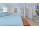 Bright bedroom features fresh white walls, soft blue accents, and convenient access to an ensuite bathroom at 309 South Dr, Nokomis, FL 34275
