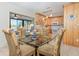 Bright dining area with a glass table, comfortable chairs, and a view of the water at 309 South Dr, Nokomis, FL 34275