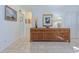 Bright hallway with tile flooring and natural light, complemented by a stylish wooden console table at 309 South Dr, Nokomis, FL 34275
